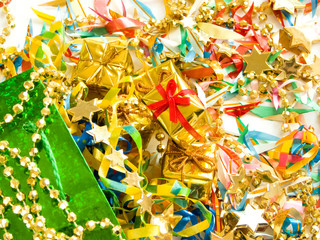 Small golden gifts around colored confetti. Shallow DOF.