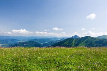 Obraz premium Mountain-ridge and blue sky with white clouds