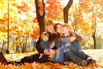 Family on autumn leaves