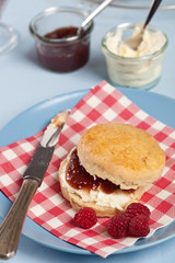 Scone with clotted cream and raspberry jam