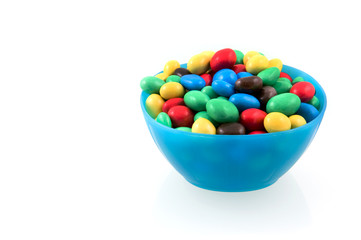 Colorful chocolate balls in blue bowl