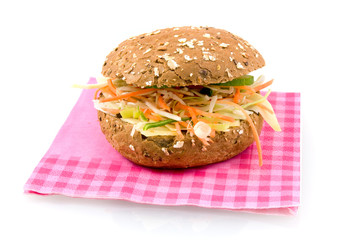 Brown sandwich filled with cheese and lettuce