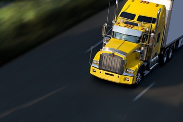 speed yellow semi-truck on highway