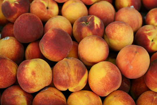 close-up of juicy ripen peaches as background