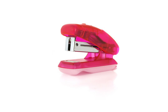 Small pink stapler isolated on white