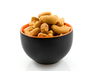 Bowl with cashew nuts over white background
