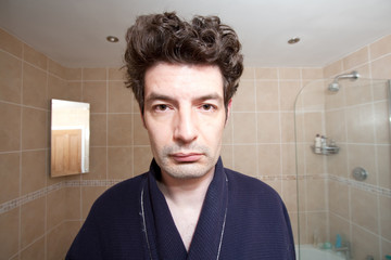 A Tired Man Looking in the Mirror