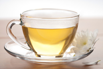 cup of green tea and white flower