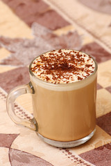 mug of capuccino on table
