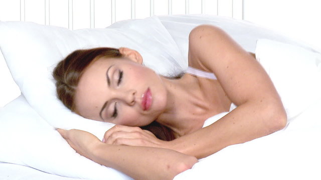 Beautiful woman sleeping on white bed at her home