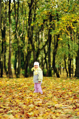 girl playing in autumn park