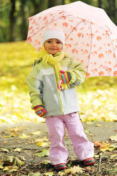 girl playing in autumn park