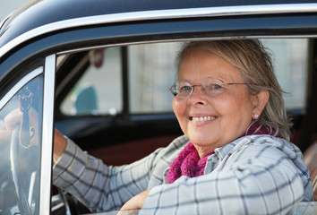 Senior woman in oldtimer car