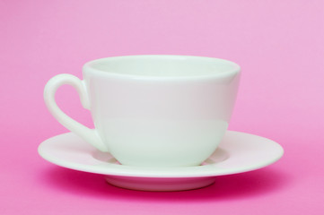 White cup isolated on the pink background