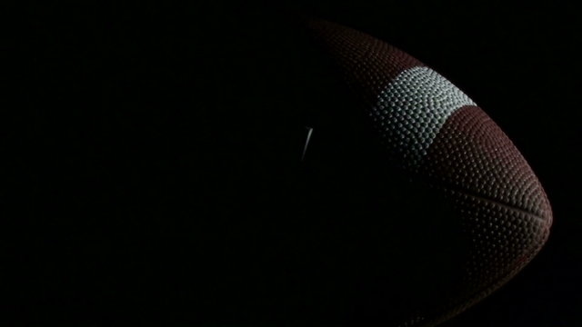 Football rotates against black - HD