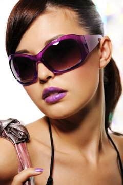 Beautiful woman with purple fashion sunglasses