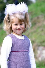 Portrait of a pretty small girl standing outdoor