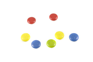 Sad face made of colored chocolates