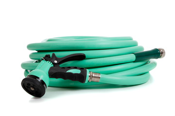 Green garden hose with spray nozzle