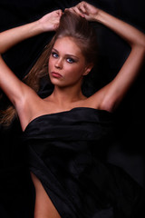 Naklejka premium beautiful woman lies on black, the top view