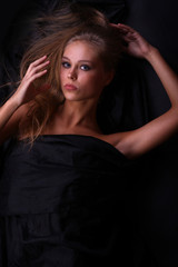 Naklejka premium beautiful woman lies on black, the top view