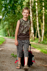 Boy walking with his suitcase