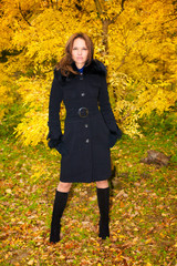 Young beautiful woman in the autumn forest