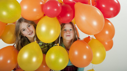 Fototapeta na wymiar young girls playing in balloons