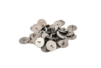 Some classic metal thumbtacks on a white background