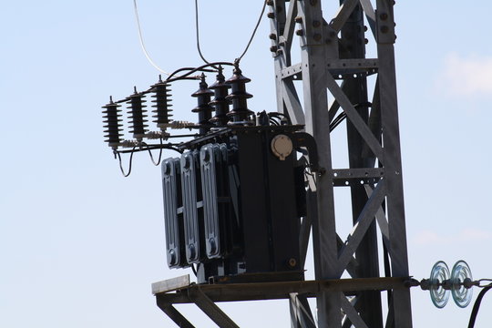 Transformador de alta tension en lo alto de un poste electrico.