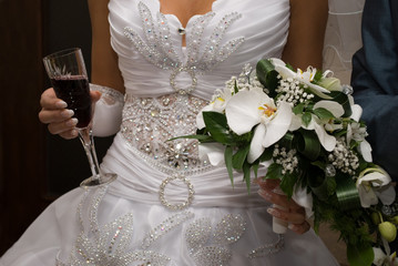 Bride hold bouquet and wine