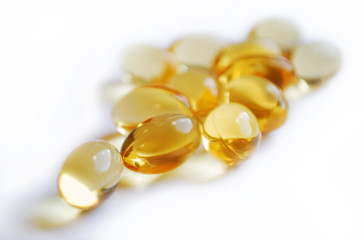 translucent capsules with blurred background over white