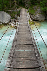 Small foot bridge made of wooden desk and steel cable