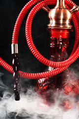 Red hookah on a black background
