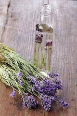 Lavender oil and a bunch of lavender flowers