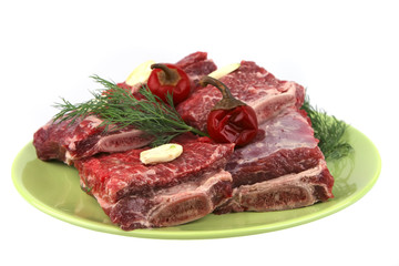 Fototapeta premium uncooked ribs on green dish
