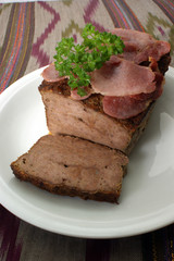 baked meat loaf with organic parsley on a plate