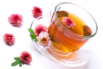 cup of herbal tea with flowers on white