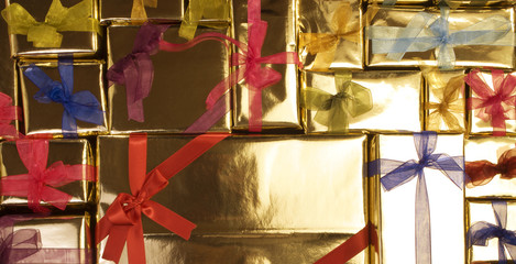 golden color giftboxes with colorful ribbons