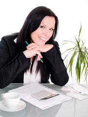 smiling brunette woman sitting with papers and calculator