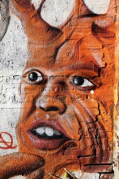 Face on the wall, urban graffiti, Milan