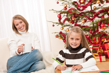 Happy blond woman with child on Christmas