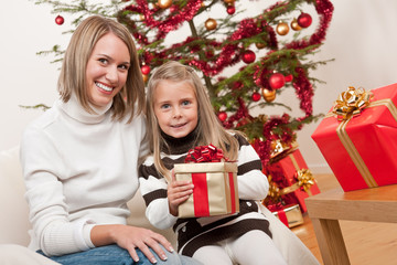 Fototapeta na wymiar Happy blond woman with child on Christmas