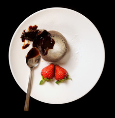 Half eaten chocolate dessert with strawberry