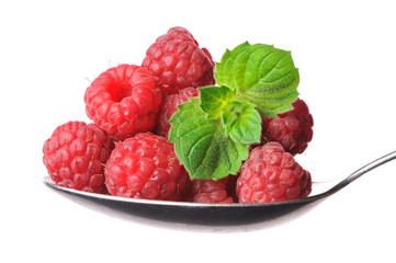 raspberry and mint on a spoon on a white background