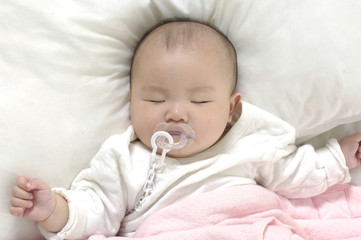 Little kid sleep on white bed