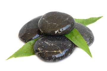 Spa stones and green leaves