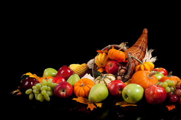 Fall arrangement of fruits and vegetables in a cornucopia
