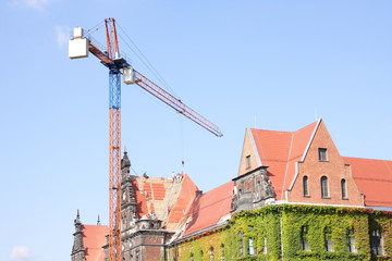 Roofers team working on historic red roof