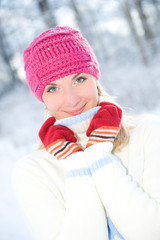 Frozen beautiful woman in winter clothing outdoors..